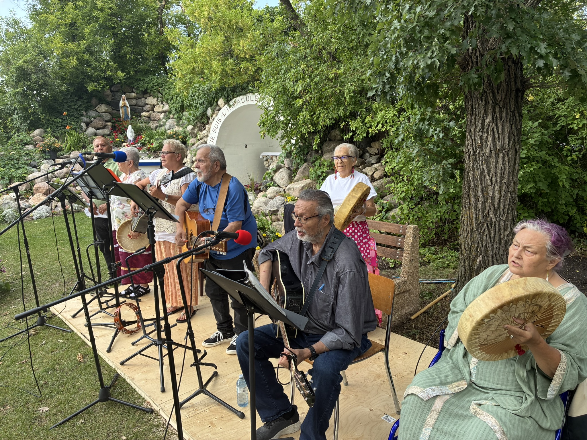 Youth and volunteers performing worship music outdoors at a church event